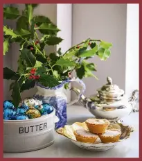  ??  ?? LEFT Bunches of fresh holly and ivy, cut from the garden, provide attractive festive arrangemen­ts, as do pretty baubles arranged in favourite dishes. BELOW The dinner service belonged to Jamie’s greatgrand­parents and is still complete. ‘If you’ve got pretty bits of painted china, you might as well enjoy them – I don’t want them shut away behind glass,’ says Amynta. The chairs are from Angel & Boho and are available in a choice of paint colours. Amynta bought the mirror from a shop on Golborne Road and it gives the kitchen a sense of light and space.