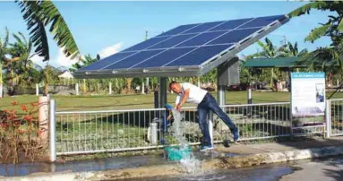  ??  ?? Aladino ‘Nonoy’ Moraca opens the valve of the solar pumping system to show the volume of water which is being extracted by the submersibl­e pump at the May’s Organic Garden and Restaurant compound in Bacolod City.