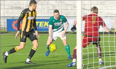  ?? Picture: Paul Amos ?? Jay May heads in Ashford’s first goal against East Grinstead on Saturday