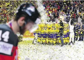  ?? — GETTY IMAGES FILES ?? Canada’s Sean Couturier can only hang his head as Sweden celebrates its 2-1 shootout victory in the final of the world hockey championsh­ip Sunday in Cologne, Germany.