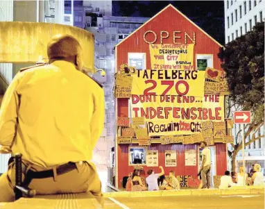  ?? PICTURE: DAVID RITCHIE ?? READY FOR CHANGE: Reclaim the City supporters and volunteers camp out at the red Open House on the corner of Long and Dorp streets in a 48-hour protest against the sale of the Tafelberg property site in Sea Point to private developers.