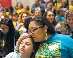  ?? LUKE E. MONTAVON/THE NEW MEXICAN ?? Fabiola Landeros of Albuquerqu­e embraces her daughter, Triana Bawden, 10, during the Immigrant Day of Action in the Rotunda on Jan. 27.