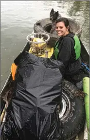  ?? (Special to the Democrat-Gazette/Michael and Tonya Sacomani) ?? Tonya Sacomani is almost crowded out of the boat by a load of trash her family found in the Saline River.