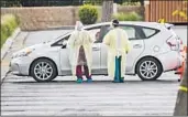  ?? Gina Ferazzi Los Angeles Times ?? HEALTHCARE workers do initial screenings at a coronaviru­s testing station in Yorba Linda.