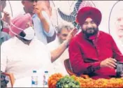  ?? RAVI KUMAR/HT ?? Newly appointed Punjab Congress chief Navjot Singh Sidhu with chief minister Capt Amarinder Singh during the installati­on ceremony in Chandigarh on Friday.