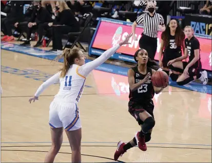  ?? PHOTOS BY MARCIO JOSE SANCHEZ — THE ASSOCIATED PRESS ?? Stanford guard Kiana Williams (23) drives past UCLA forward Emily Bessoir during the first half on Monday in Los Angeles.