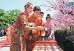  ?? PROVIDED TO CHINA DAILY ?? Traditiona­l dress is worn as employees at Alibaba, including those from overseas, marry in Hangzhou, Zhejiang province.