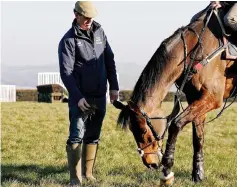  ?? — AFP photo ?? Trainer Jamie Snowden on the gallops with one of his out-riders at his stables in Lambourn, Berkshire, west of London.