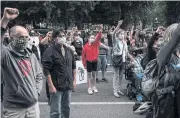  ?? AFP ?? Protesters raise their hands in solidarity at the Multnomah County Justice Center in Portland, Oregon, on Friday.