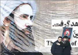  ?? Vahid Salemi
Associated Press ?? IN TEHRAN, men take a selfie with a poster of Sheik Nimr al-Nimr, who was executed last week by Saudi Arabia, setting off protests across the Mideast.