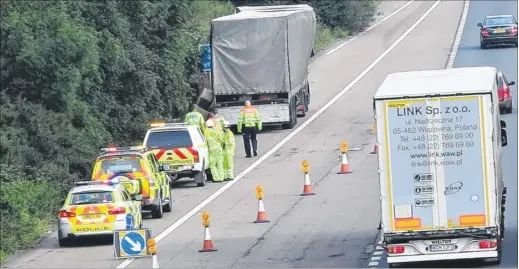  ?? Picture: Andy Clark ?? Highways Agency staff attend to the lorry on Thursday afternoon