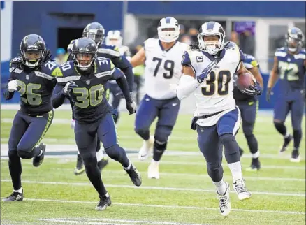  ?? Photograph­s by Steve Dykes Getty Images ?? TODD GURLEY and the Rams suddenly are running away with the division after Gurley rushed for a season-high 152 yards and scored four touchdowns at Seattle, where the Seahawks had previously held the highest-scoring team, the Eagles, to 10 points.