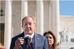  ?? Associated Press ?? ■ Texas Attorney General Ken Paxton, left, next to his wife and Texas State Sen. Angela Paxton, speaks to anti-abortion activists Nov. 1, 2021 at a rally outside the Supreme Court on Capitol Hill in Washington.