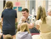  ?? PAUL W. GILLESPIE/STAFF ?? Fifth grade teacher Bradley Absher reacts to being announced as the Milken Educator Award winner. The Bodkin Elementary School teacher was awarded a surprise $25,000 during a school assembly Thursday.