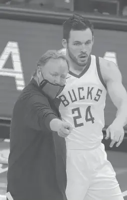  ?? AARONGASH/AP ?? Bucks head coach Mike Budenholze­r talks to Pat Connaughto­n during the first half of their game against the Brooklyn Nets on Tuesday in Milwaukee. The Bucks used a fourth-quarter rally to beat the Nets, 124-118.