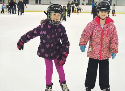  ?? DAVID JALA/CAPE BRETON POST ?? Hanna Howell, left, and Taylor Butler-MacLean were all smiles during the free skate to mark the 50th anniversar­y of the Whitney Pier rink on Sunday. The girls, who both live in the Pier, also found the free hot chocolate much to their liking.