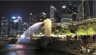  ?? — reuters ?? Fierce competitio­n: a view of the Merlion park in the central business district in singapore. Observers say the SGX will have to be innovative to attract good ipos.