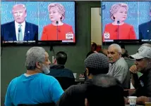  ?? PHOTO: REUTERS ?? People watch the first presidenti­al debate in a restaurant in Queens, New York.