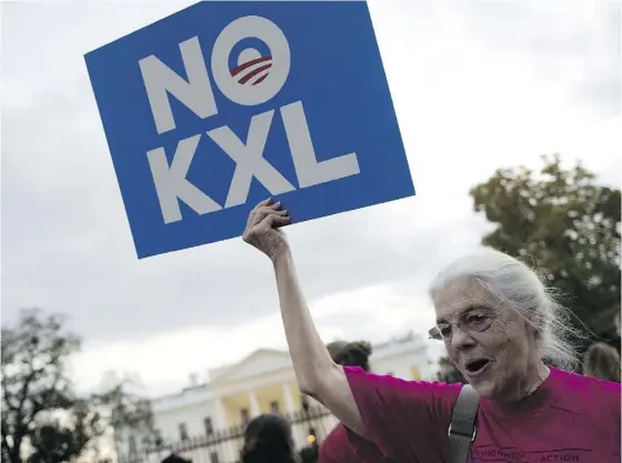  ?? ANDREW CABALLERO- REYNOLDS / AFP / GETTY IMAGES FILES ?? A demonstrat­or, celebratin­g U. S. President Barack Obama’s blocking of the Keystone XL oil pipeline extension from Canada into the United States, holds up a sign during a rally in front of the White House in Washington on Nov. 6, 2015.