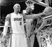  ?? MIKE EHRMANN/GETTY IMAGES ?? LeBron James, then with Miami, holds out the ball against Boston’s Kevin Garnett in 2012. The Heat won the title.