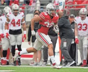  ?? ADAM CAIRNS/COLUMBUS DISPATCH ?? Ohio State running back TreVeyon Henderson carries during the Buckeyes’ spring game Saturday.