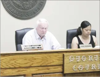  ?? Brodie Johnson • Times-Herald ?? St. Francis County Judge Gary Hughes and County Clerk Brandi McCoy review documents during Tuesday’s Quorum Court meeting at the courthouse. Justices are considerin­g a $2 per hour raise for county employees for a minimum of two years.