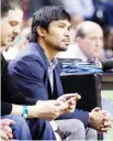  ??  ?? Boxer Manny Pacquiao watches the game between the Miami Heat and the Milwaukee Bucks during the first half of an NBA basketball game in Miami, Tuesday. (AP)