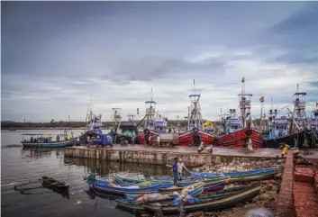  ?? — PTI ?? Boats are anchored at a dock due to a red alert for Cyclone Nisarga in Ratnagiri district, Maharashtr­a, on Tuesday. Movement of people along the Mumbai coastline has been prohibited.