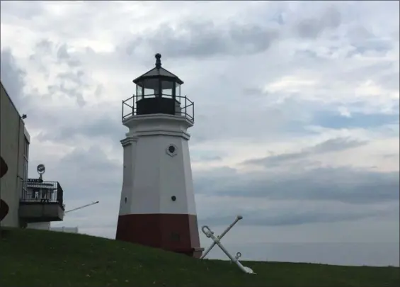  ?? KEVIN MARTIN — THE MORNING JOURNAL ?? A replica of Vermilion’s former lighthouse originally constructe­d in 1877 stands tall outside the Inland Seas Maritime Museum, underscori­ng the city’s maritime roots.