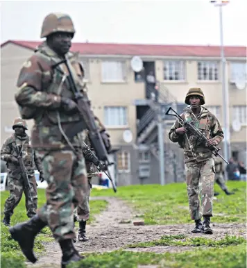  ??  ?? Soldiers were greeted with cheers when they arrived in Cape Flats on Thursday, but locals feared the killings would continue when they left