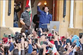 ?? REUTERS ?? Saad al-Hariri, who suspended his decision to resign as Prime Minister, gestures to his supporters at his home in Beirut, Lebanon, on Wednesday.
