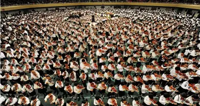  ??  ?? Ranks of genius: (above) the 52nd Suzuki Method Grand Concert, 2009, in which 3,000 children played on the violin, cello and flute; (above left) children sing and play instrument­s following Carl Orff’s Das Schulwerk method