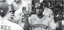  ??  ?? Yordan Alvarez is greeted after hitting a solo home run in the fifth inning. It was Alvarez’s 28th homer of the season.