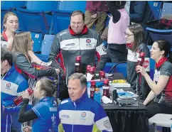  ??  ?? Marcel Rocque, centre, talks with the team during a break at the Scotties Tournament of Hearts at Centre 200 in Sydney, N.S. on Monday. — THE CANADIAN PRESS