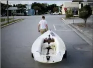  ?? DAVID GOLDMAN—THE ASSOCIATED PRESS ?? Emmett West pulls his boat from a nearby marina to secure it at his home ahead Hurricane Florence in Morehead City, N.C., Tuesday.