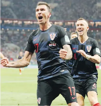  ?? FRANK AUGSTEIN, THE ASSOCIATED PRESS ?? Croatia’s Mario Mandzukic celebrates after scoring his side’s second goal during extra time against England in Moscow on Wednesday.