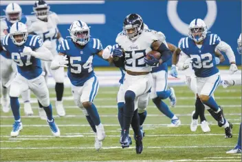  ?? AP photo ?? Titans running back Derrick Henry is chased by Colts defenders during Tennessee’s 45-26 win over Indianapol­is on Sunday. Henry ran for 178 yards and three touchdowns.