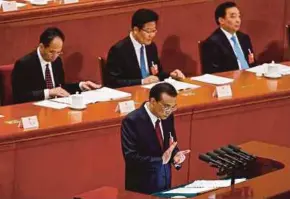  ??  ?? China Premier Li Keqiang delivering a speech during the opening of the first Plenary Session of the 13th National People’s Congress in Beijing yesterday. EPA PIC