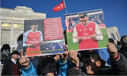  ?? Photograph: Ozan Köse/AFP via Getty Images ?? Supporters of China’s Muslim Uighur minority hold placards of Arsenal’s Mesut Özil during a demonstrat­ion in Istanbul.