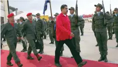 ?? — Reuters ?? Venezuela’s President Nicolas Maduro (C) receives military honours at Maiquetia airport in Caracas on Thursday.