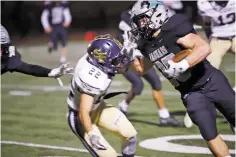  ??  ?? Capital’s Luke Padilla, right, tries to escape Santa Fe High’s Joaquin Martinez. Padilla rushed for 196 yards and two touchdowns in the 28-0 win.