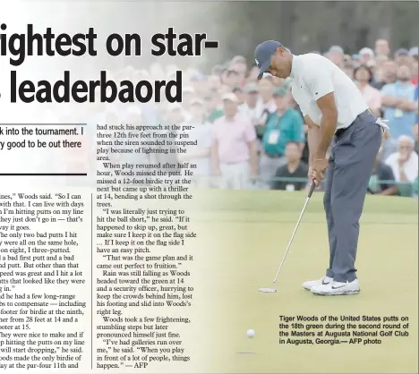  ?? AFP photo ?? Tiger Woods of the United states putts on the 18th green during the second round of the Masters at augusta national golf club in augusta, georgia.—