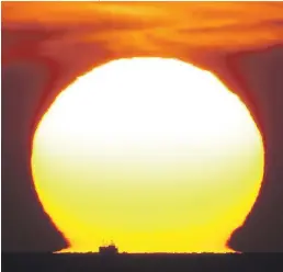  ?? Picture: OWEN HUMPHREYS / PA ?? Stunning sunrise forms a dazzling backdrop for a tiny fishing boat off the coast of Whitley Bay, Tyne and Wear, at dawn yesterday