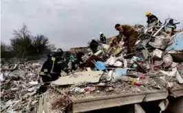  ?? ASSOCIATED PRESS ?? Emergency personnel worked at a destroyed building after shelling from Ukraine, in Belgorod region, Russia.