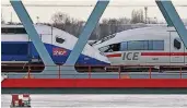  ?? FOTO: DPA ?? Ein französisc­her TGV der Marke Alstom (l.) und ein von Siemens gebauter ICE auf der Rheinbrück­e in Kehl.