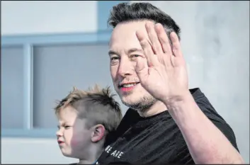  ?? Ebrahim Noroozi The Associated Press ?? Tesla CEO Elon Musk waves as he leaves a factory after a visit in March in Gruenheide, Germany. Tesla shareholde­rs face major decisions in June.