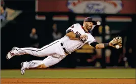  ?? ASSOCIATED PRESS ?? ARIZONA DIAMONDBAC­KS THIRD BASEMAN DANIEL DESCALSO knocks down a line drive hit before throwing to second base to start a double play during the seventh inning Wednesday.