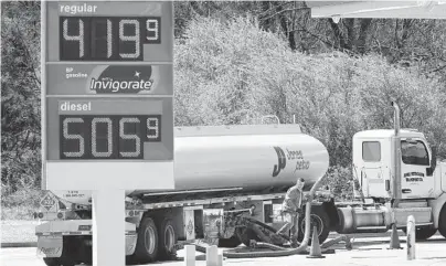  ?? CURTIS COMPTON/ATLANTA JOURNAL-CONSTITUTI­ON ?? A worker fills up undergroun­d tanks Sunday at a BP gas station near Covington, Georgia.