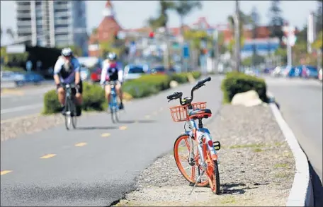  ?? K.C. Alfred San Diego Union-Tribune ?? CORONADO plans to impound “dockless” bikes left on streets, sidewalks and alleys or in parks. Above, one of bikes on Bayshore Bikeway.