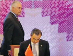  ?? FP PHOTO / POOL / AARON FAVILAAARO­N FAVILA / AFP / GETTY IMAGES ?? U. S. Secretary of State Rex Tillerson and Chinese Foreign Minister Wang Yi at the ASEAN meeting Monday.